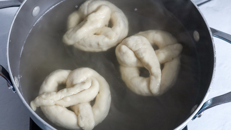 soft pretzels boiling in pot