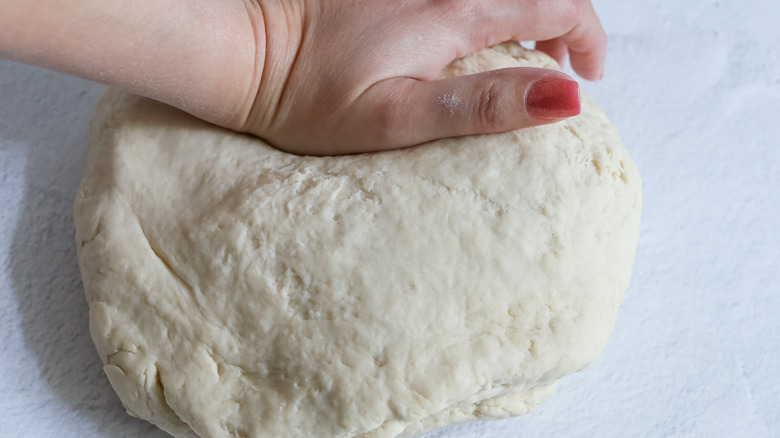 kneading ball of pretzel dough