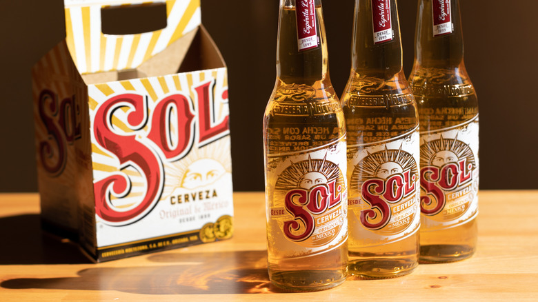 Bottles of Sol beer outside of four-pack packaging