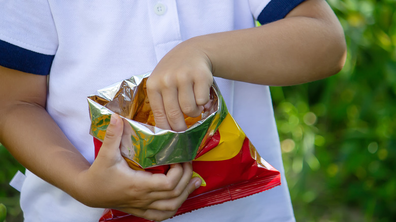 Child reaching into snack bag