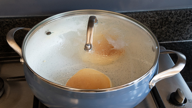 pancakes in pan with lid