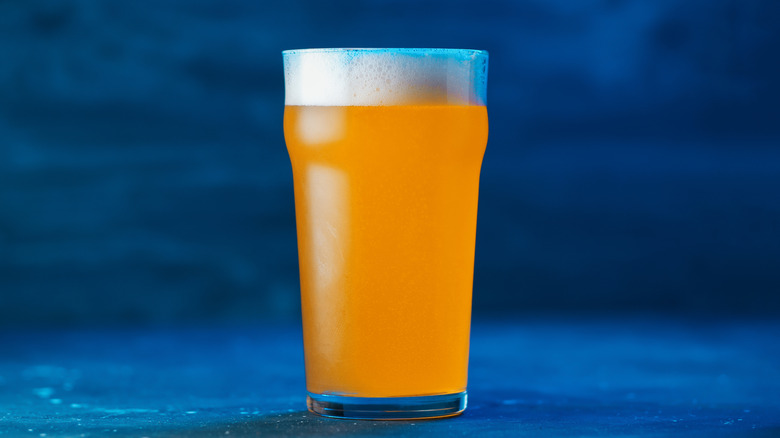 beer in glass blue background