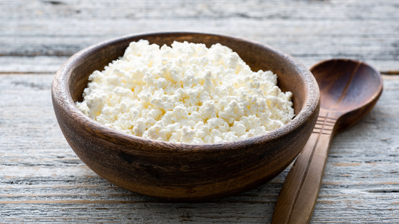 Ricotta cheese in wooden bowl
