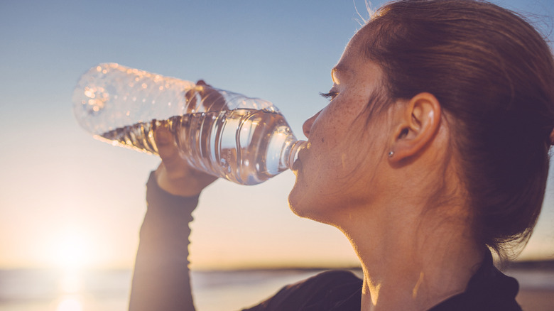 Woman drinking bottled water