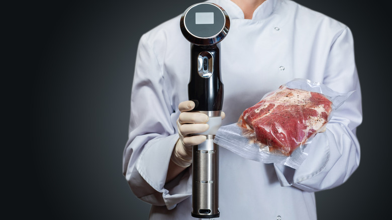 chef holding immersion circulator