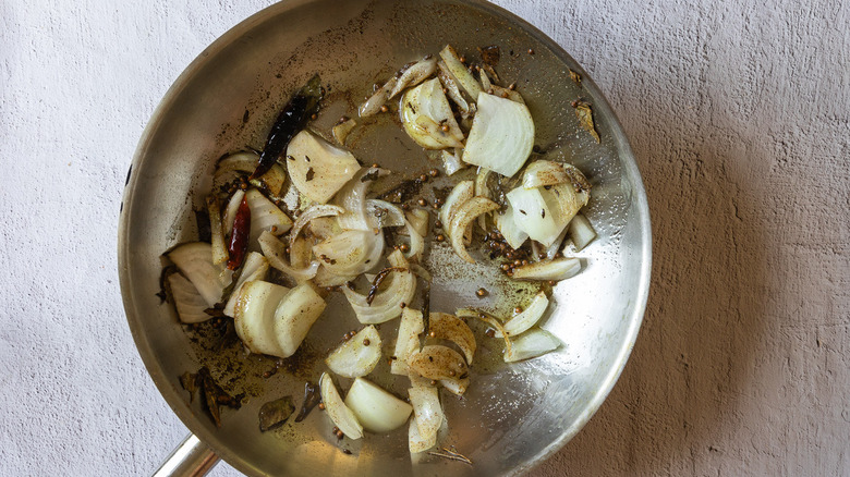 Onions and spices in pan