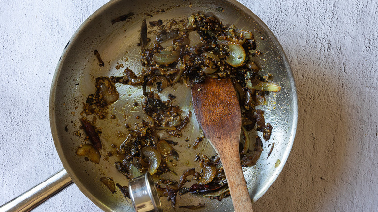 Onions and spices in pan