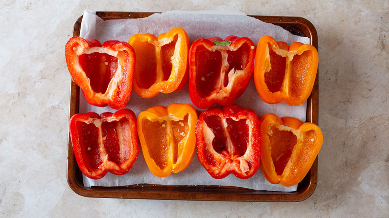 Empty bell pepper halves on baking sheet