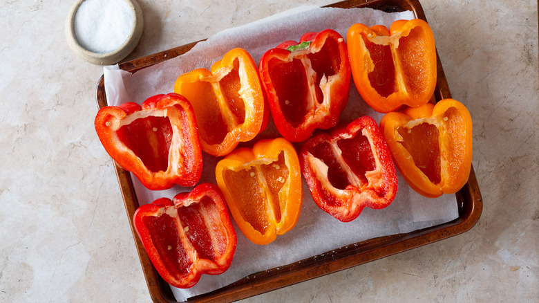 Empty bell pepper halves on baking sheet