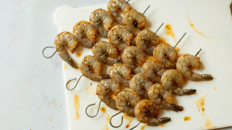 uncooked shrimp on skewers