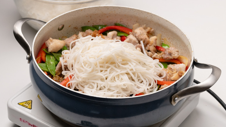 assembling stir-fry in a pan