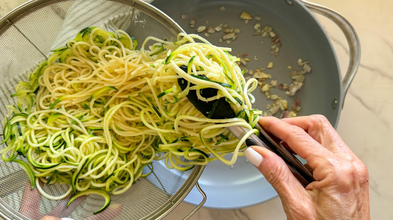 adding noodles to pan