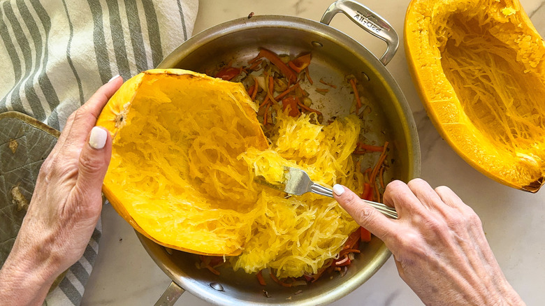 shredding squash into pan