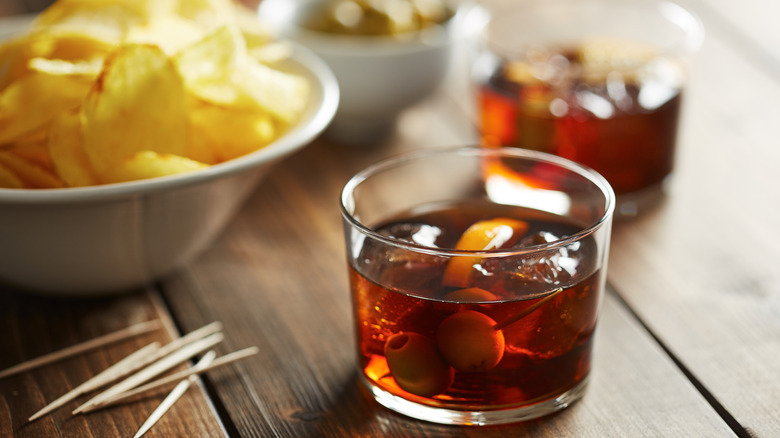 cocktail poured next to chips