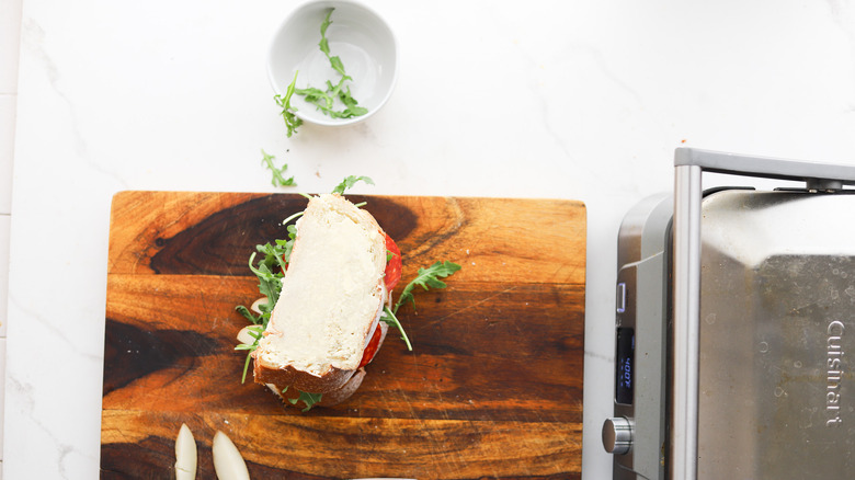 Buttered sandwich on cutting board