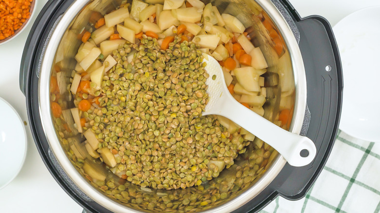 Top down view of green lentils, carrots, potatoes in an Instant Pot