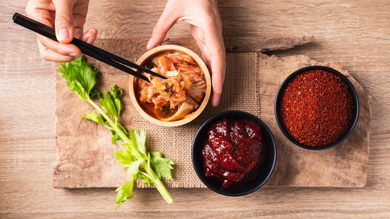 Bowls of kimchi, gochujang, and chili powder