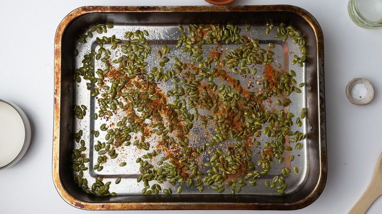 Pumpkin seeds on baking sheet from above