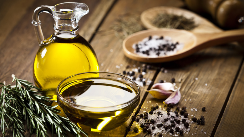 bowl of oil with fresh herbs and spices