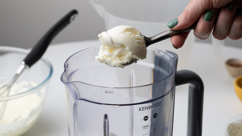 Adding ice cream to a blender 