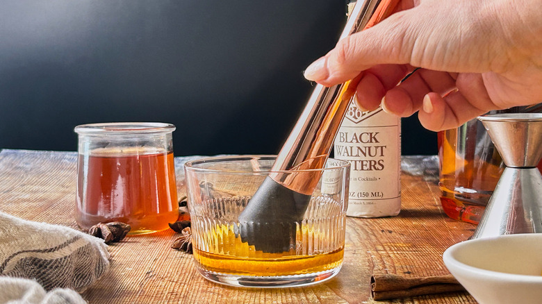 muddling orange in glass