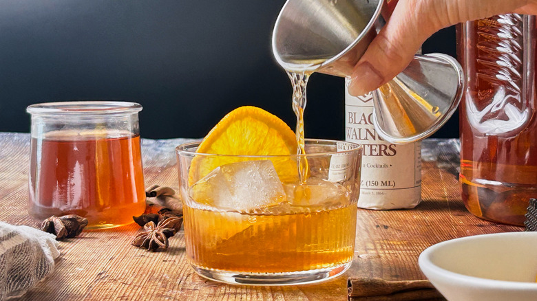 pouring bourbon over ice