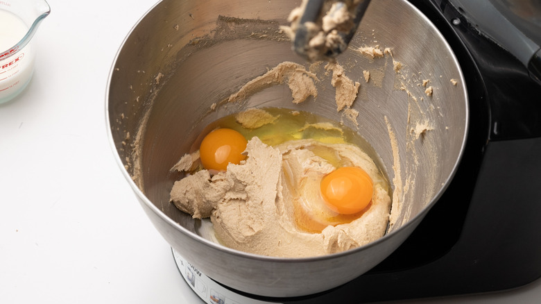 adding eggs to buttercream mixture