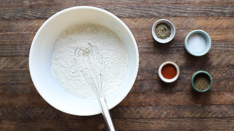 bowl of flour with whisk and spices