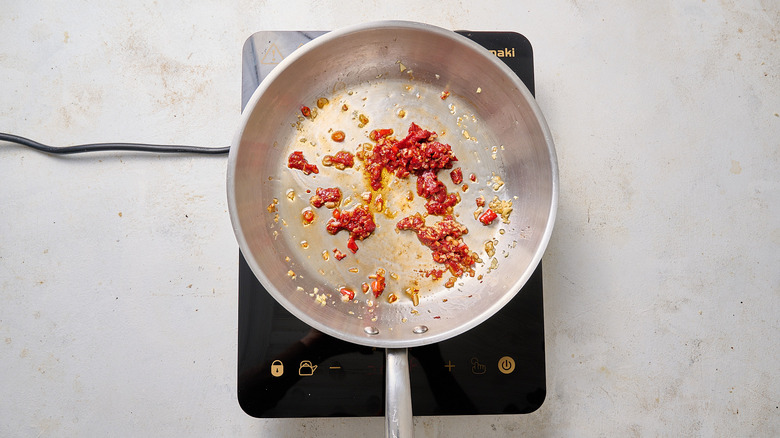 cooking tomato paste in skillet