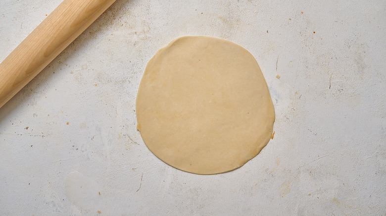 rolling dough into circle