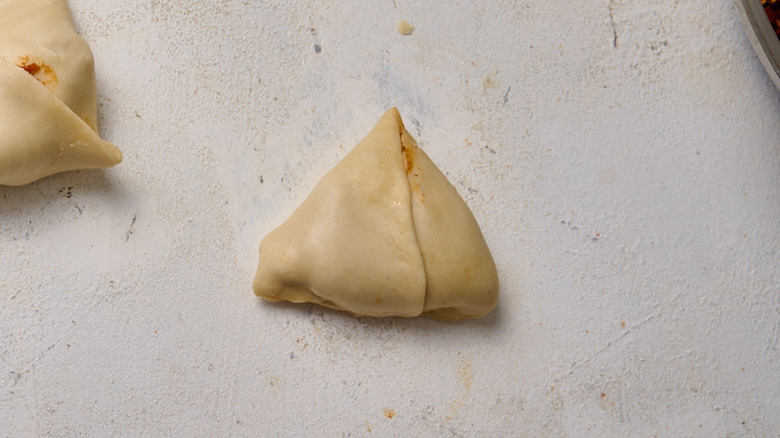 folded samosa on table