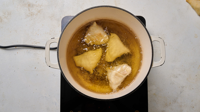 frying samosas in oil