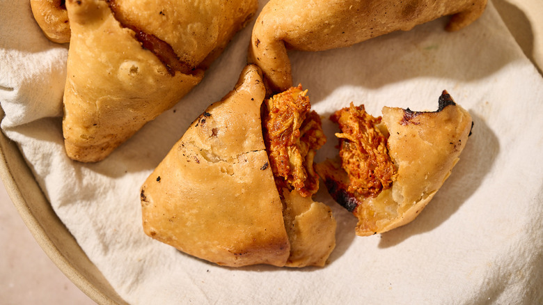 samosa with chicken curry on table