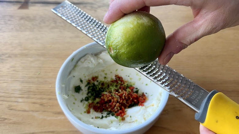 zesting lime into spicy cream cheese