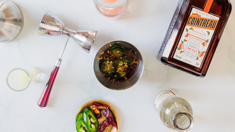 Adding ingredients to cocktail shaker