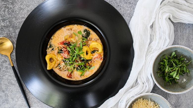 orange soup with black bowl