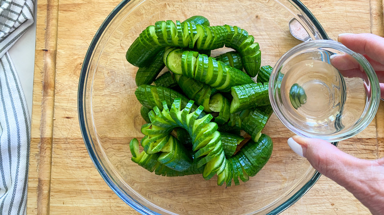 adding  vinegar to cucumbers