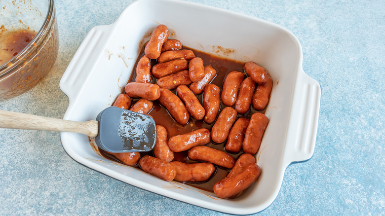 putting sauce on sausages