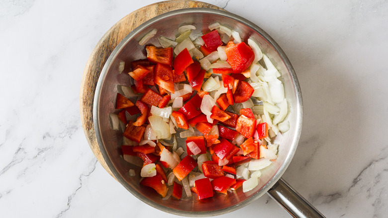 Bell peppers and onions in pan