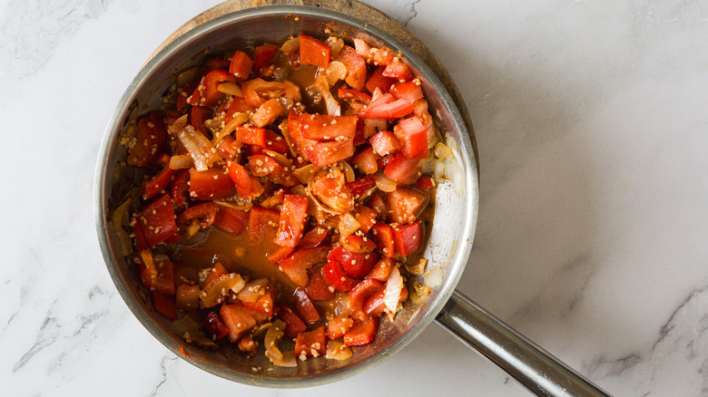 Bell peppers, onions and tomatoes in pan