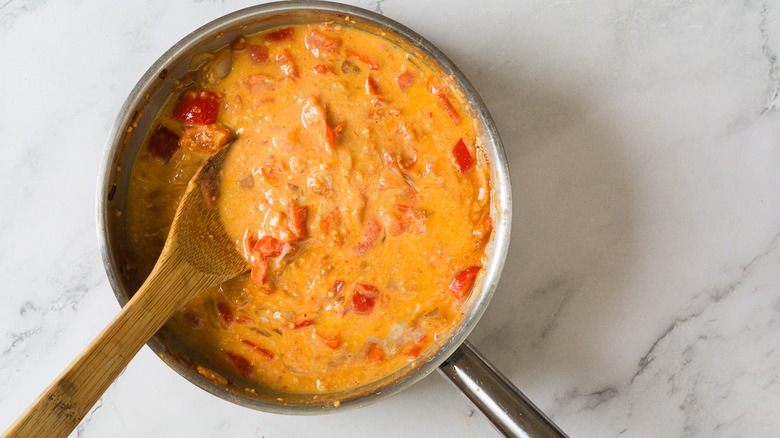 Tomato sauce with eggs in pan with spatula