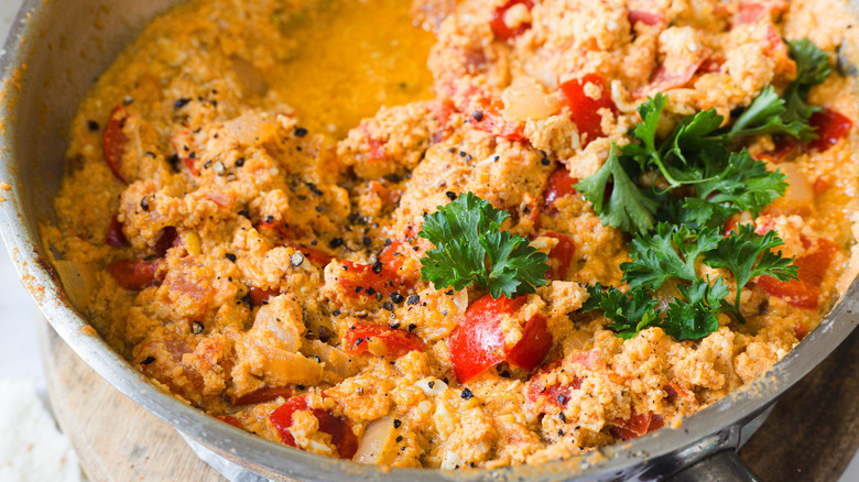 Close up on tomatoes and parsley in eggs