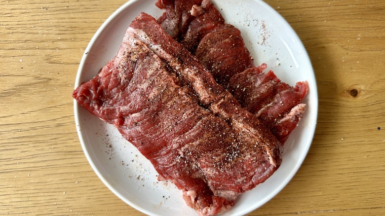 raw steak on white plate