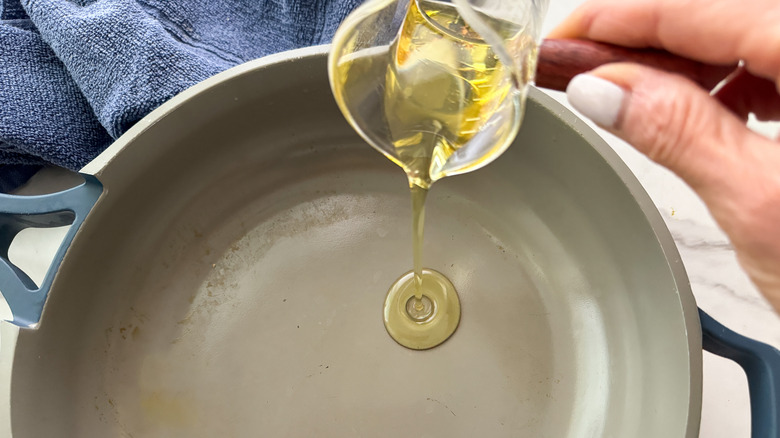 adding oil to pan