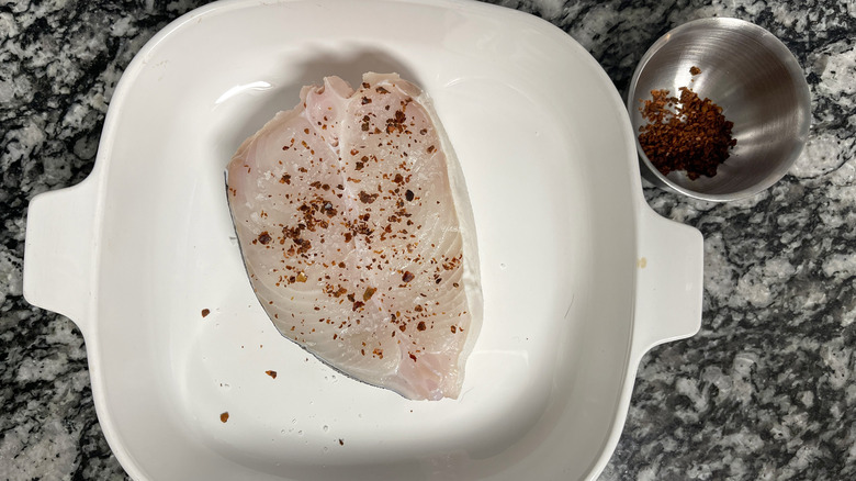 seasoned halibut fillet in pan