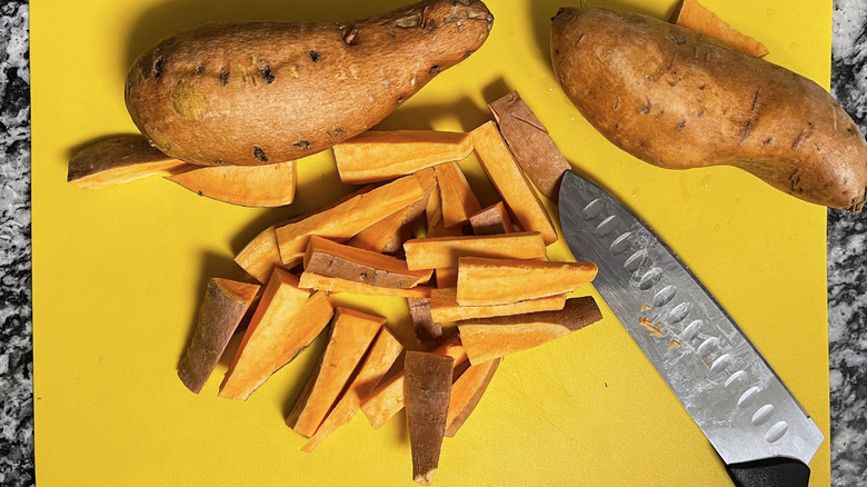 chopped sweet potatoes and knife