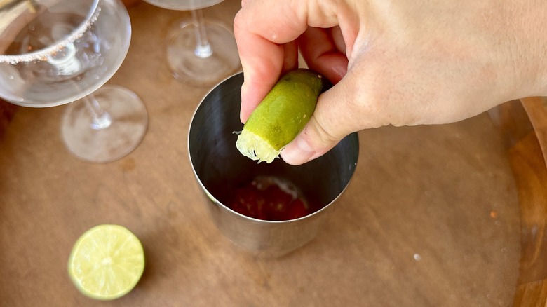 squeezing lime juice into shaker