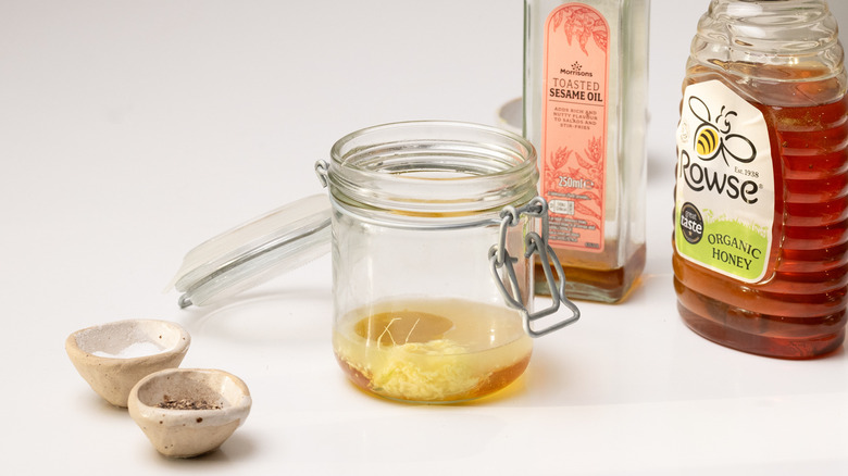 Jar with liquid ingredients, sesame oil, and honey