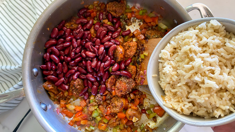 adding beans to frying pan