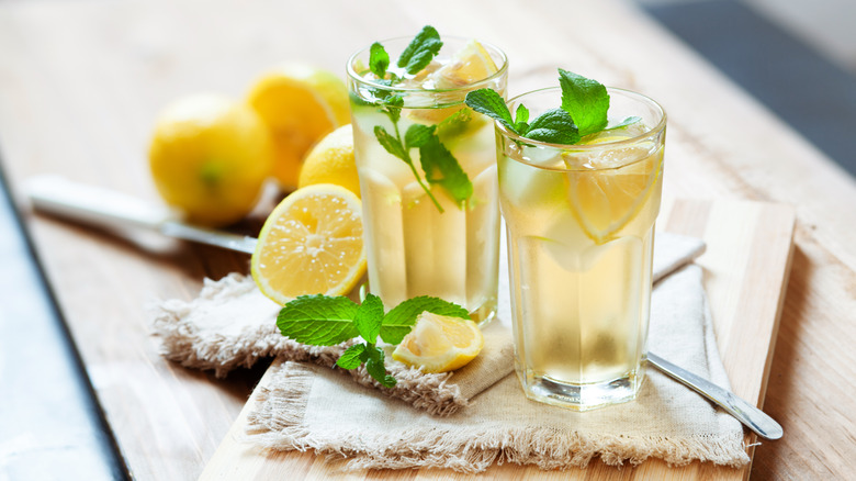 Two glasses of bourbon lemonade with fresh mint